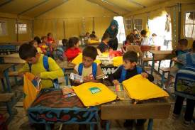 Children in Syria use ShelterBox's SchoolBoxes to continue learning during relief efforts (courtesy of ShelterBox)