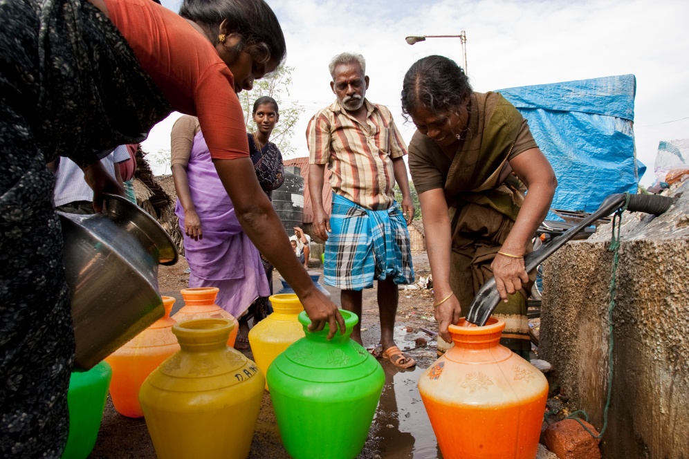 Residents draw water in one of the slums of Chennai, Tamil Nadu, India.