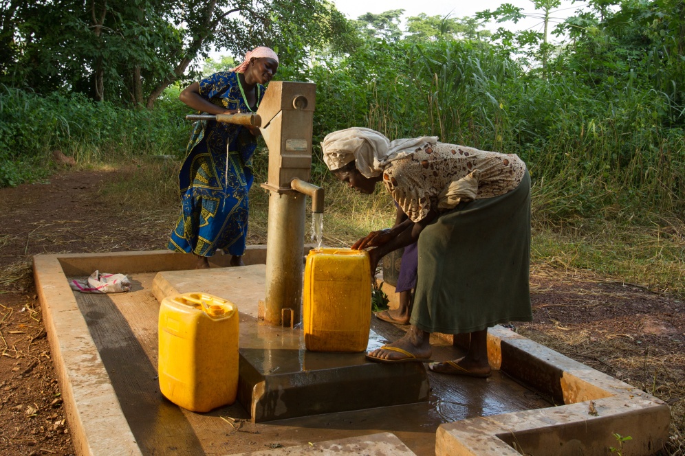 Women operate a repaired well in the village of Do Meabra, Ghana.