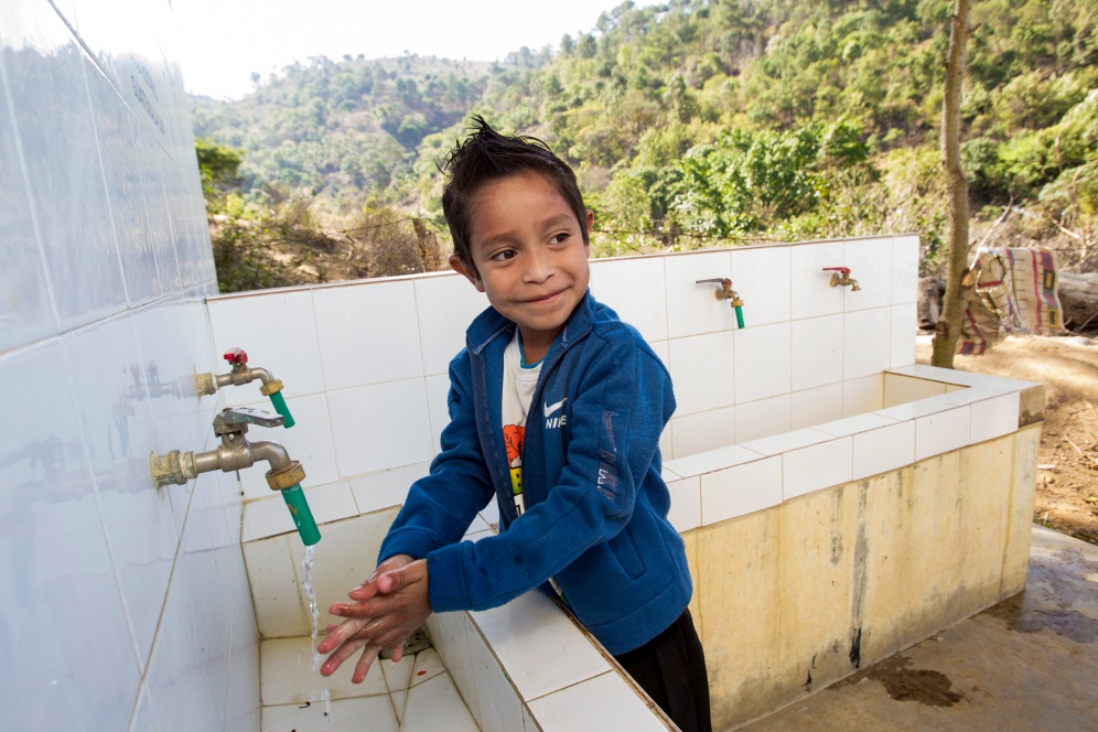A student washes his hands after using the bathroom at El Tunino school. The school is one of nine in the Sumpango area of Guatemala at which Rotary is improving water and sanitation facilities through a global grant.